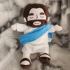 A plush toy depicting a bearded man with dark skin and a blue cloth draped around his neck.