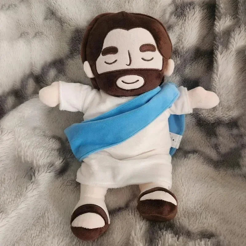 A plush toy depicting a bearded man with dark skin and a blue cloth draped around his neck.
