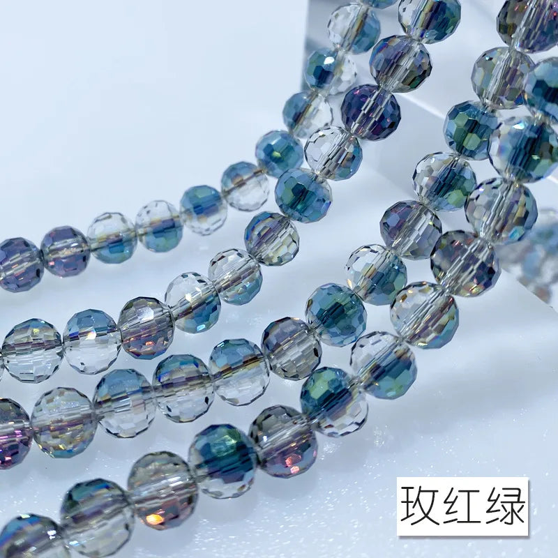 A close-up of a strand of blue and purple Austrian crystal beads with an AB coating.