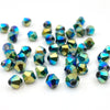 A collection of faceted bicone crystal glass beads in various shades of blue and green.