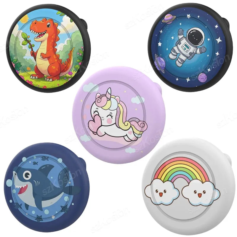 A collection of silicone airtag safety pin holders featuring a dinosaur, an astronaut, and a whale design.