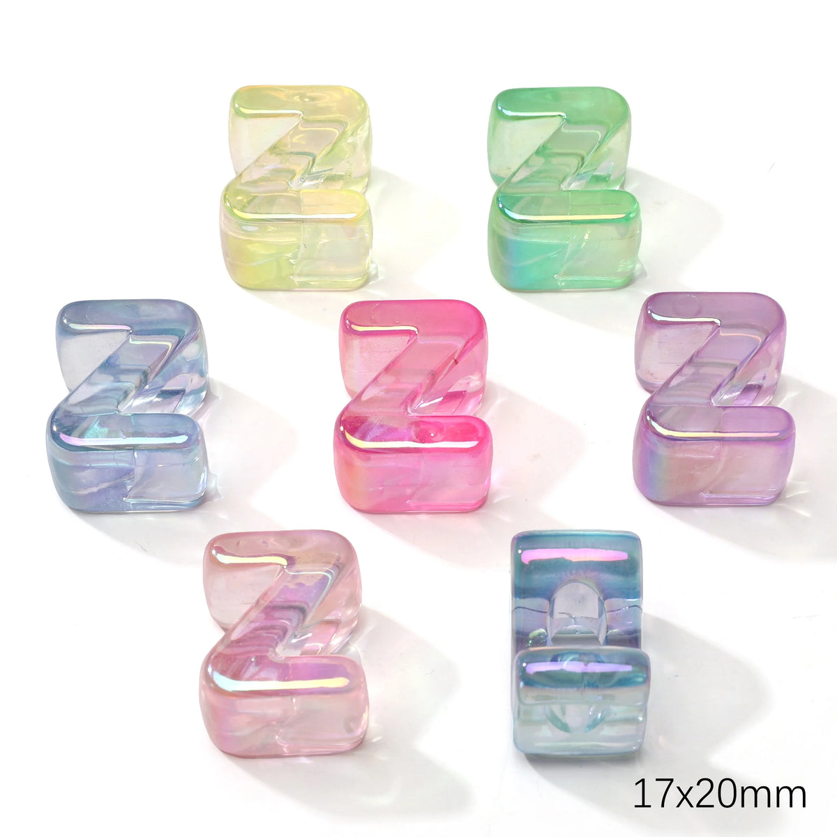 A collection of colorful acrylic alphabet beads in various shades of green, blue, and pink, shaped like the letter Z.