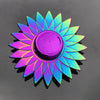 A rainbow metal fidget spinner with a smooth, iridescent rotation, displaying vibrant blue and purple colors.