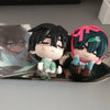 A blind box figure of a character with black hair and pink accents is displayed on a silver tray.