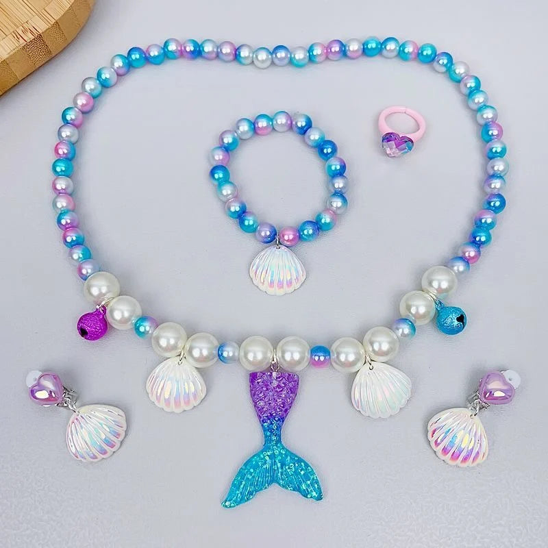A set of five mermaid pearl jewelry pieces including a necklace, bracelet, and earrings in shades of blue, purple, and white.