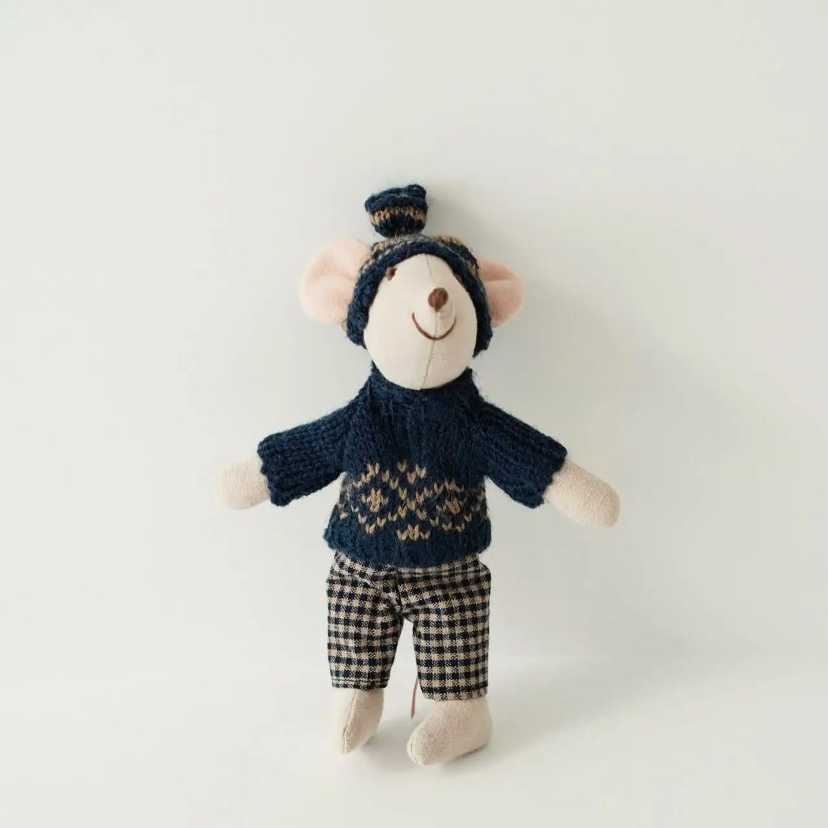 A handmade mouse plush doll wearing a navy knitted top and checkered pants.