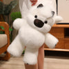 A white plush toy resembling a West Highland Calf or running cow doll is being held by a person.
