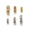 A collection of gold and silver crystal rondelle spacer beads for jewelry making.