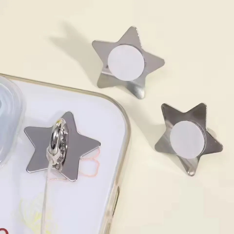 Silver star-shaped phone charm hook with a circular opening and adhesive backing