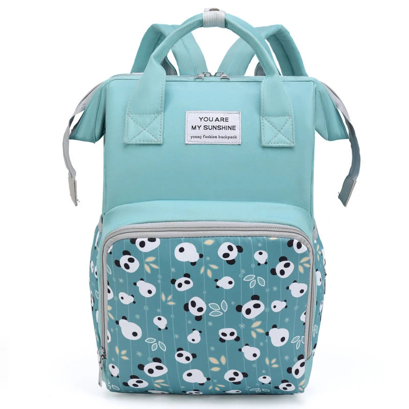 A teal mommy backpack with a light blue patterned fabric and gray straps.