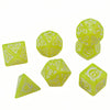 A set of yellow translucent polyhedral dice featuring dragon-inspired designs for tabletop role-playing games