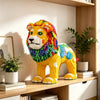 A yellow lion figure made of micro building blocks is displayed on a wooden shelf next to a potted plant.