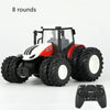 A red and white remote control tractor model with large tires is shown next to its 2.4G controller.