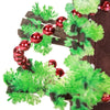 A dark brown tree decorated with bright red spherical ornaments and vibrant green foliage.
