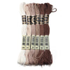 A set of six skeins of vibrant embroidery thread in various shades of beige and brown for cross stitch and DIY crafts
