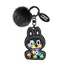 A black Labubu figurine charm with a fuzzy pom-pom and a 0.0 to 10 rating display.