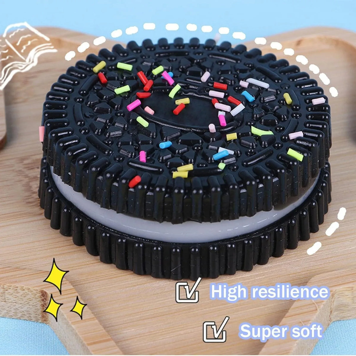 A black squishy stress relief toy with colorful confetti on top, shown on a wooden cutting board.