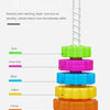 A colorful rainbow spin tower stacking toy with stacked rings in various colors like green, pink, blue, yellow, orange, red, 