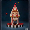 A collectible figurine of a character wearing a striped conical hat and overalls, standing on a circular base.