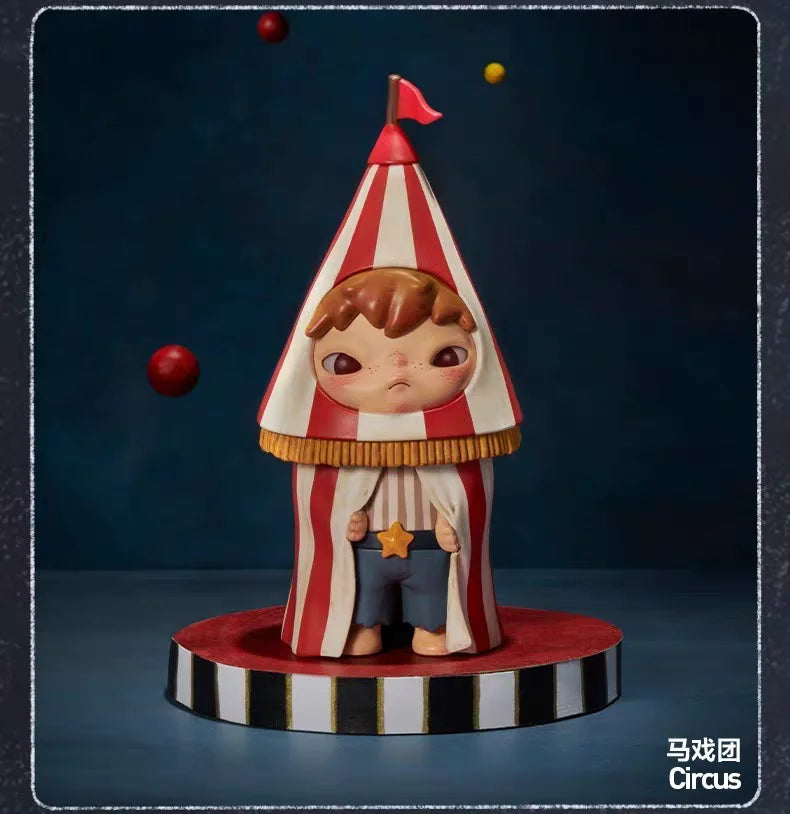 A collectible figurine of a character wearing a striped conical hat and overalls, standing on a circular base.