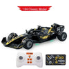 A black 1:64 classic model F1 remote control race car with an accompanying controller and app