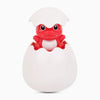A white shower toy shaped like an egg with a red cartoon monkey face and water sprinkler.