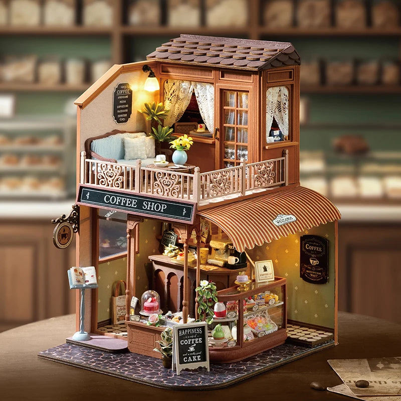 A detailed wooden miniature dollhouse kit of a coffee shop with an awning and display window.