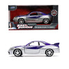 Diecast collectible of a 1995 Nissan Skyline GT-R in silver and blue paint shown in a box and as a model car.