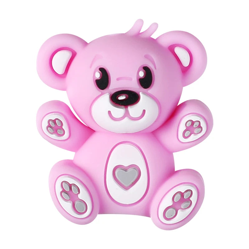 A pink silicone bear charm with facial features and paw prints for DIY jewelry making