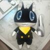 A black and white plush doll of Persona 5 Morgana with large blue eyes and yellow clothing.