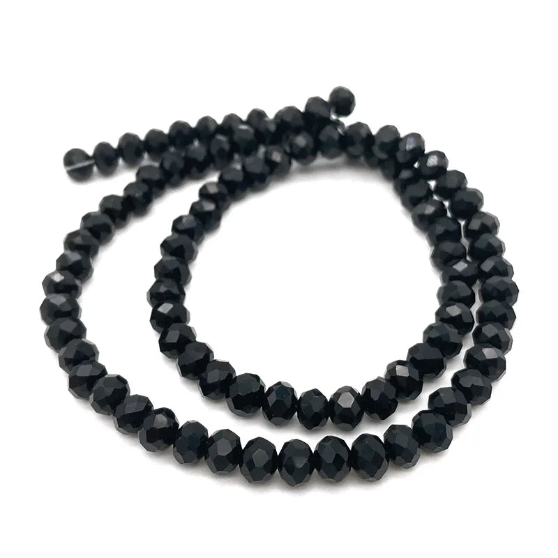A strand of black faceted crystal beads used for jewelry making