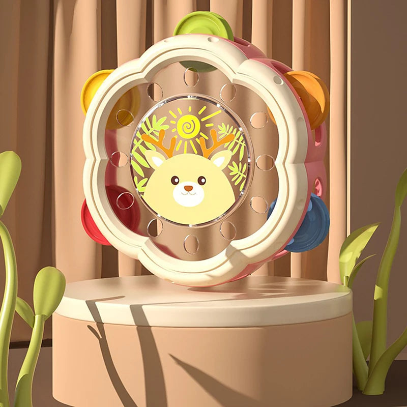A pink and yellow baby musical instrument set featuring a hand drum and shake rattle for toddlers.