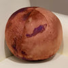A round, brown plush toy resembling a celestial body with purple markings.