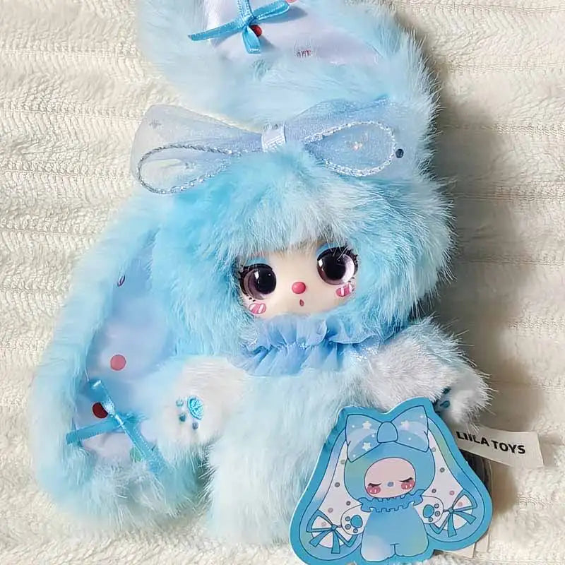 A fluffy light blue bunny plush toy with a bow and pink accents.