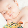 A light green toy phone shaped like a car with cat ears and wheels, resting on white fur, used for babies.