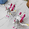 A white and pink transforming dinosaur car toy with a horse-like body and wings on a marble surface.