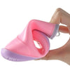 A hand holds a pink and purple kids' rain boot, showing the flexible design.