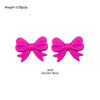 A pair of bright pink silicone bow tie beads used for jewelry making and craft projects.