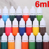 A collection of 15 small plastic bottles filled with various colored liquid paint for art projects