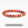A bracelet made of 1A Natural Red Jasper beads, featuring various shades of reddish-orange and pink jasper stones.