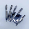A set of five miniature metal kitchen knives with handles displayed on a light gray background.