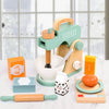 A wooden pretend play tea party set featuring a teapot, cups, and rolling pin on a white surface.