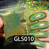 A hand holds a bottle of holographic rainbow nail glitter and several manicured nails coated with the iridescent finish.