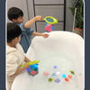 Two children play with glow-in-the-dark animal washing water toys in a white tub.