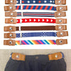 A collection of various colored canvas belts with elastic stretch featuring different patterns and finishes.
