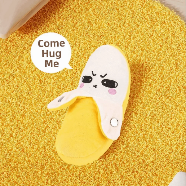 A yellow fruit-shaped metronome toy with a sad face is placed on a yellow textured surface.