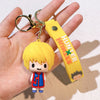 A yellow and orange resin keychain featuring an anime character from Hunter x Hunter