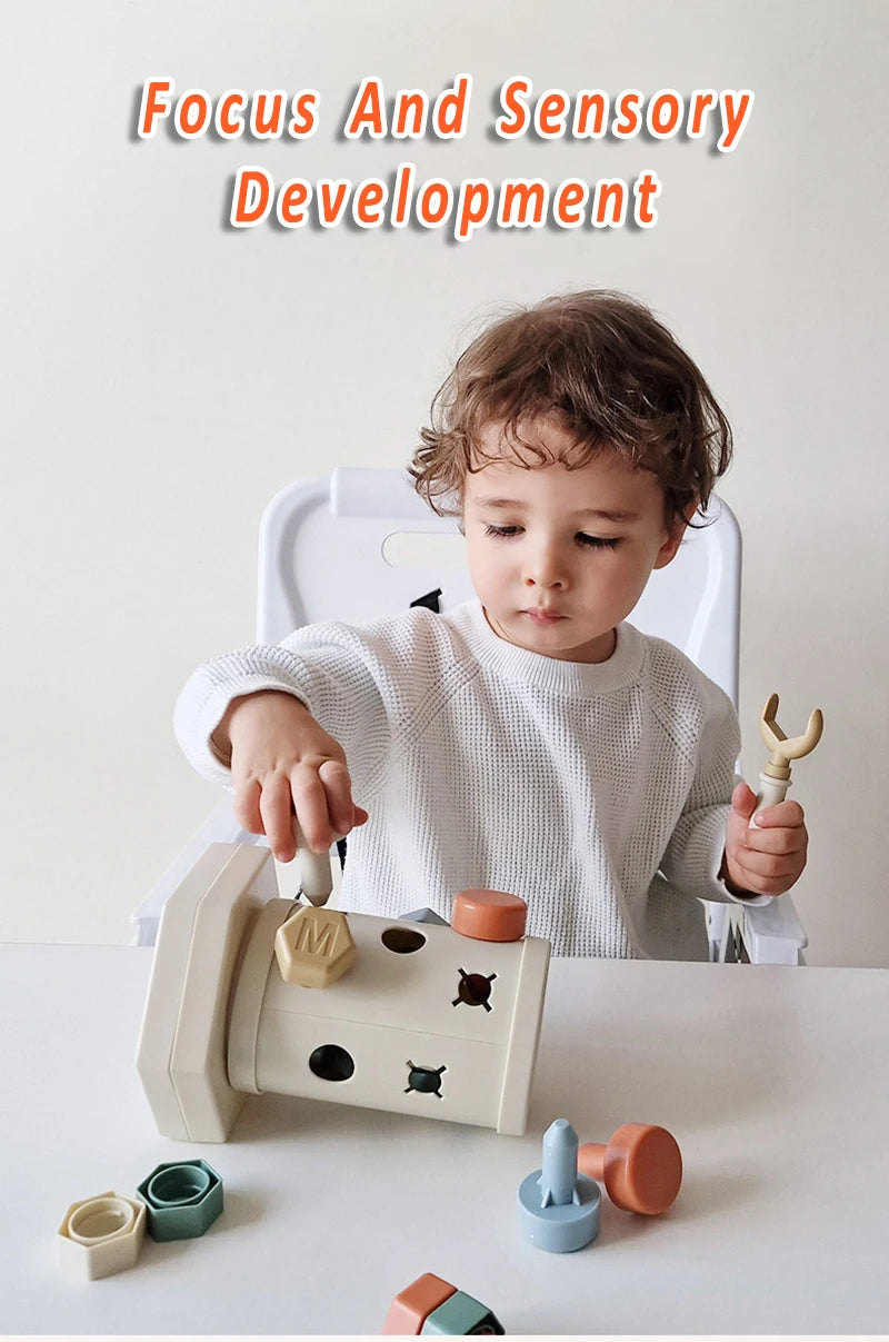 A toddler is using a white Montessori screwdriver board toy for fine motor skills and shape matching.