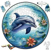 A jigsaw puzzle featuring a blue dolphin swimming in swirling blue water against a light background.