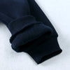 A close-up of a black knitted sleeve cuff from a kids' multicolor pullover hoodie.